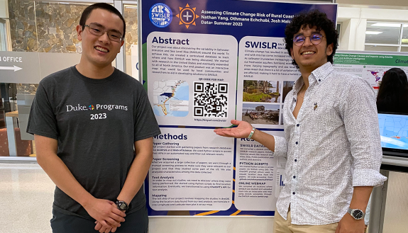 Nathan Yang ’25 (left) and Othmane Echchabi ’24 (right) in front of a poster of their work