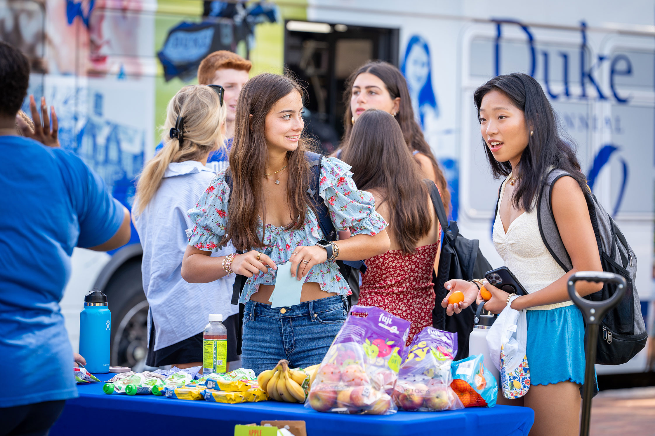 students gather fresh fruit for snacks