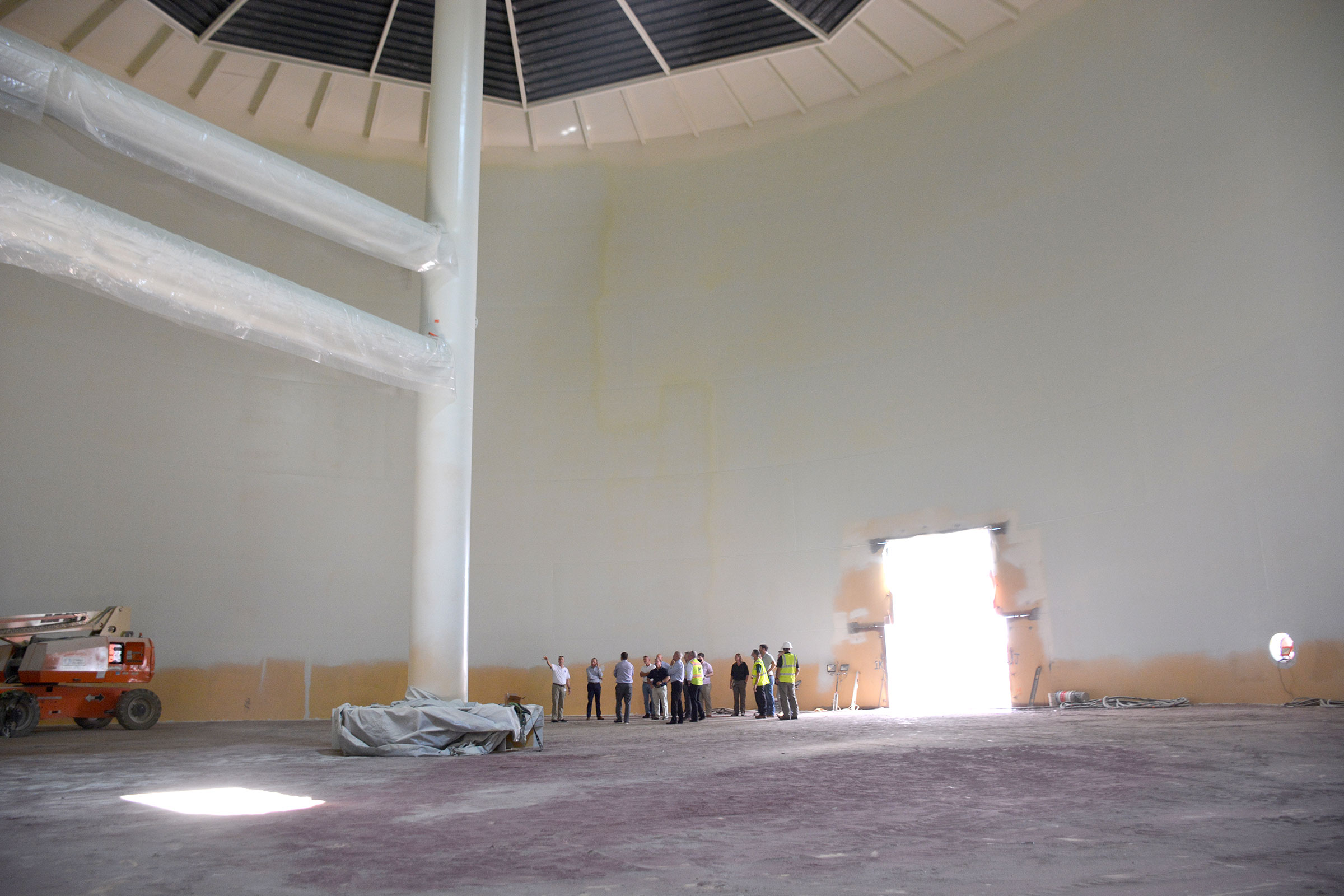 Officials toured inside Duke's 5 million gallon chilled water tank before it was filled. Chilling water at off-peak electric rates saves Duke $500,000 per year on air conditioning costs. Photo by Stephen Schramm