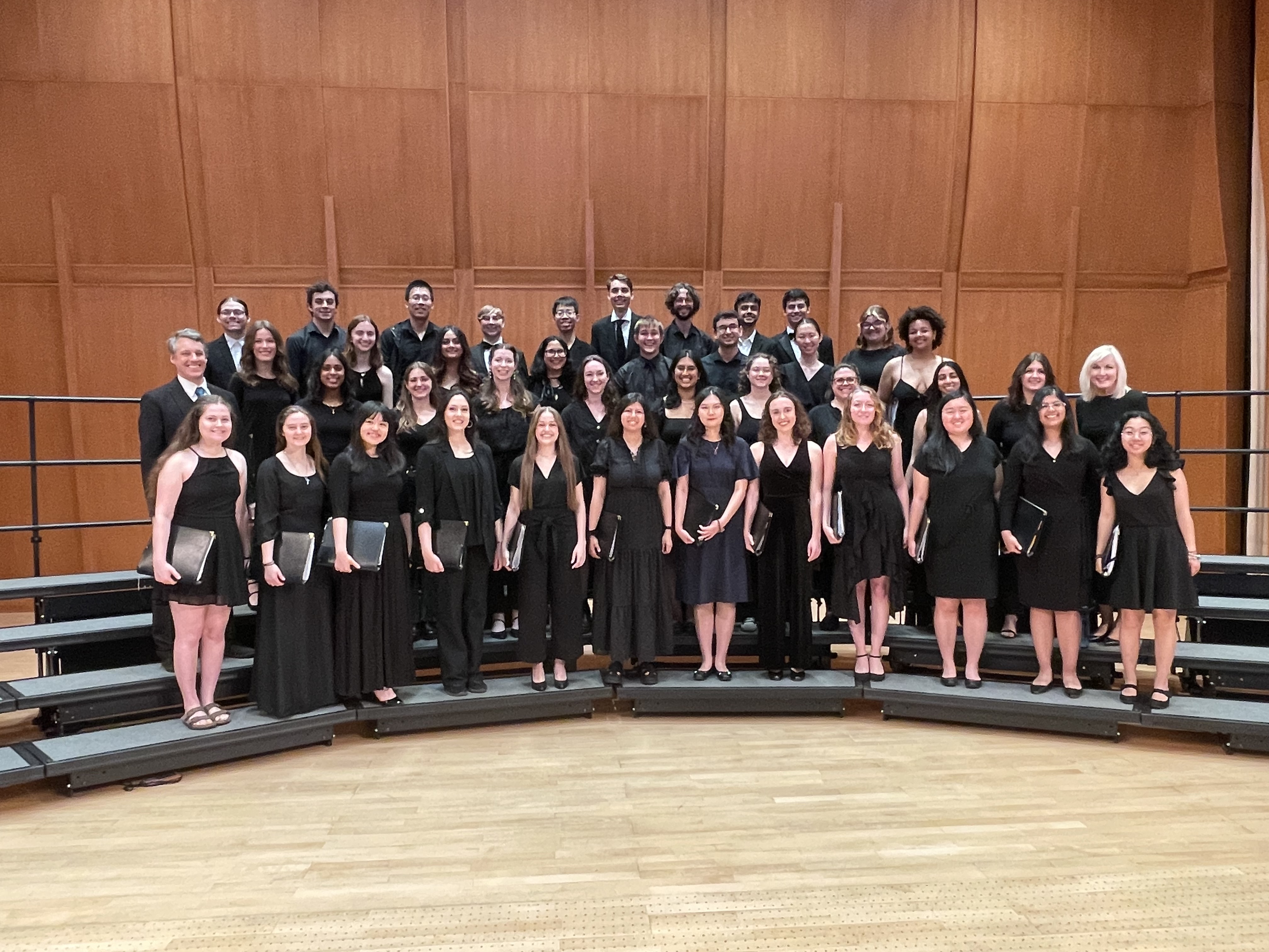 A chorale singing group stands on risers