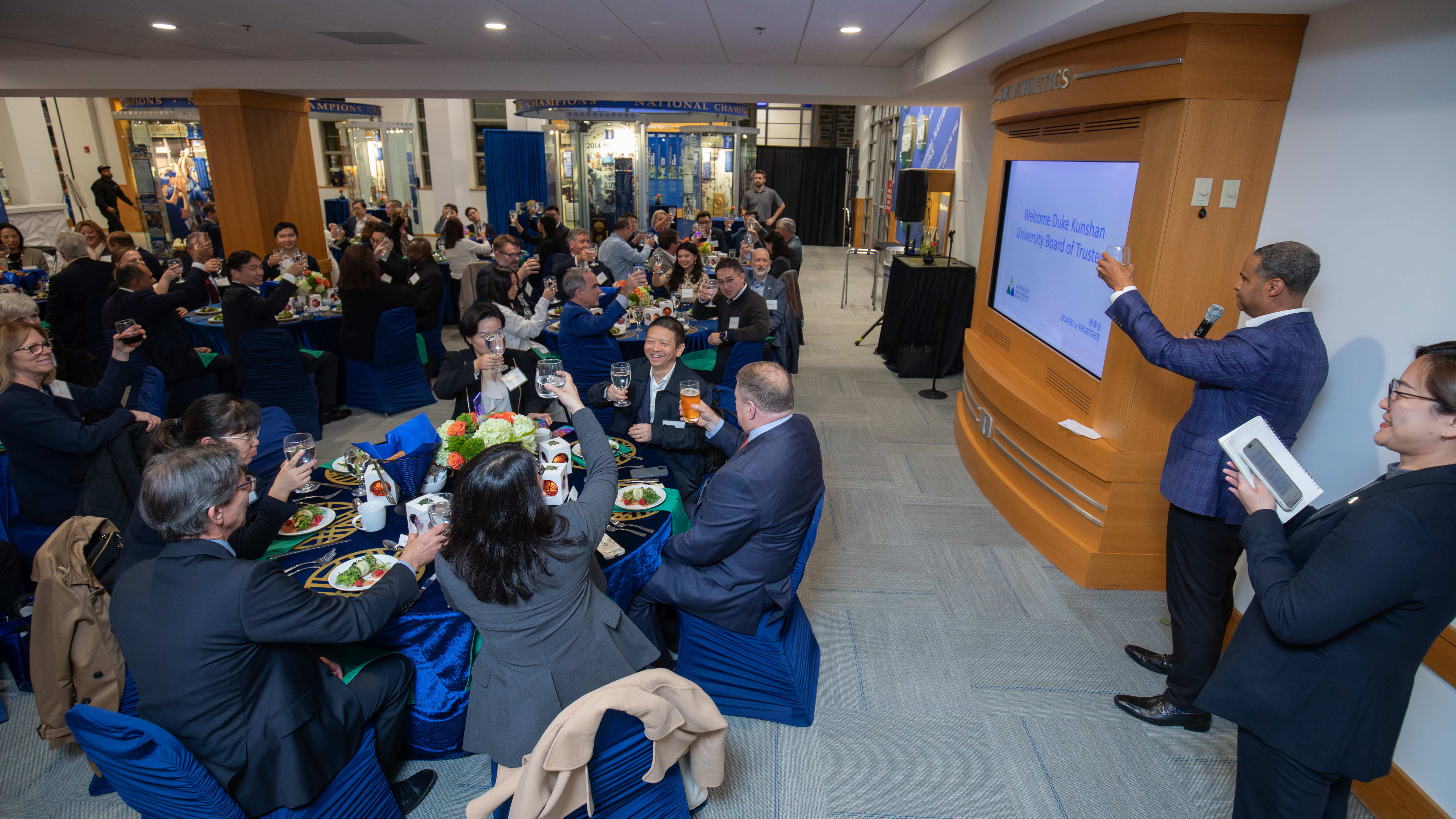 The Duke Kunshan University Board of Trustees and members from Duke toasted the partnership while dining at Cameron Indoor Stadium. Photo by Kevin Seifert