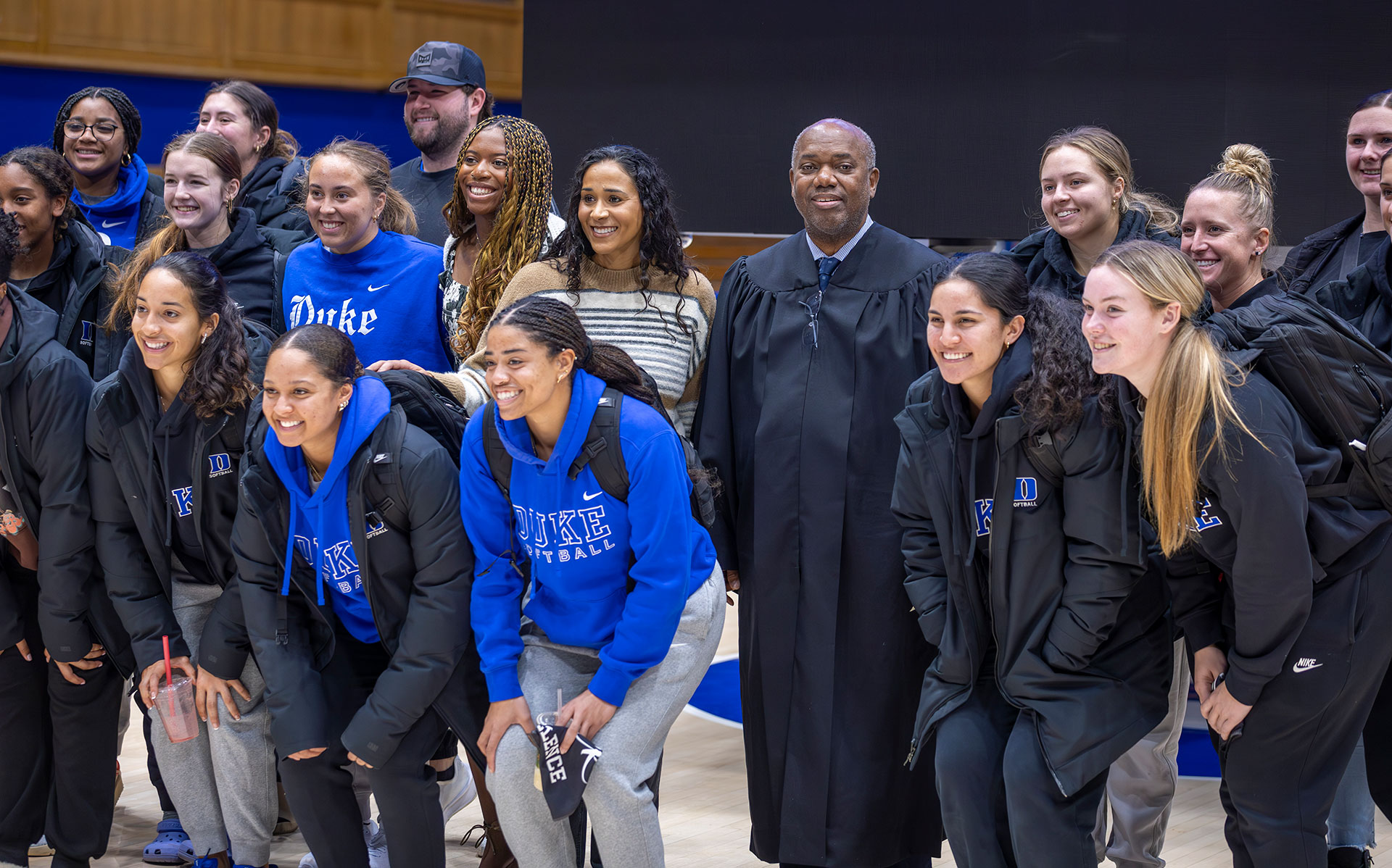 After the rally, keynote speaker Judge Jerry Blackwell poses for a photo with the Duke softball team.