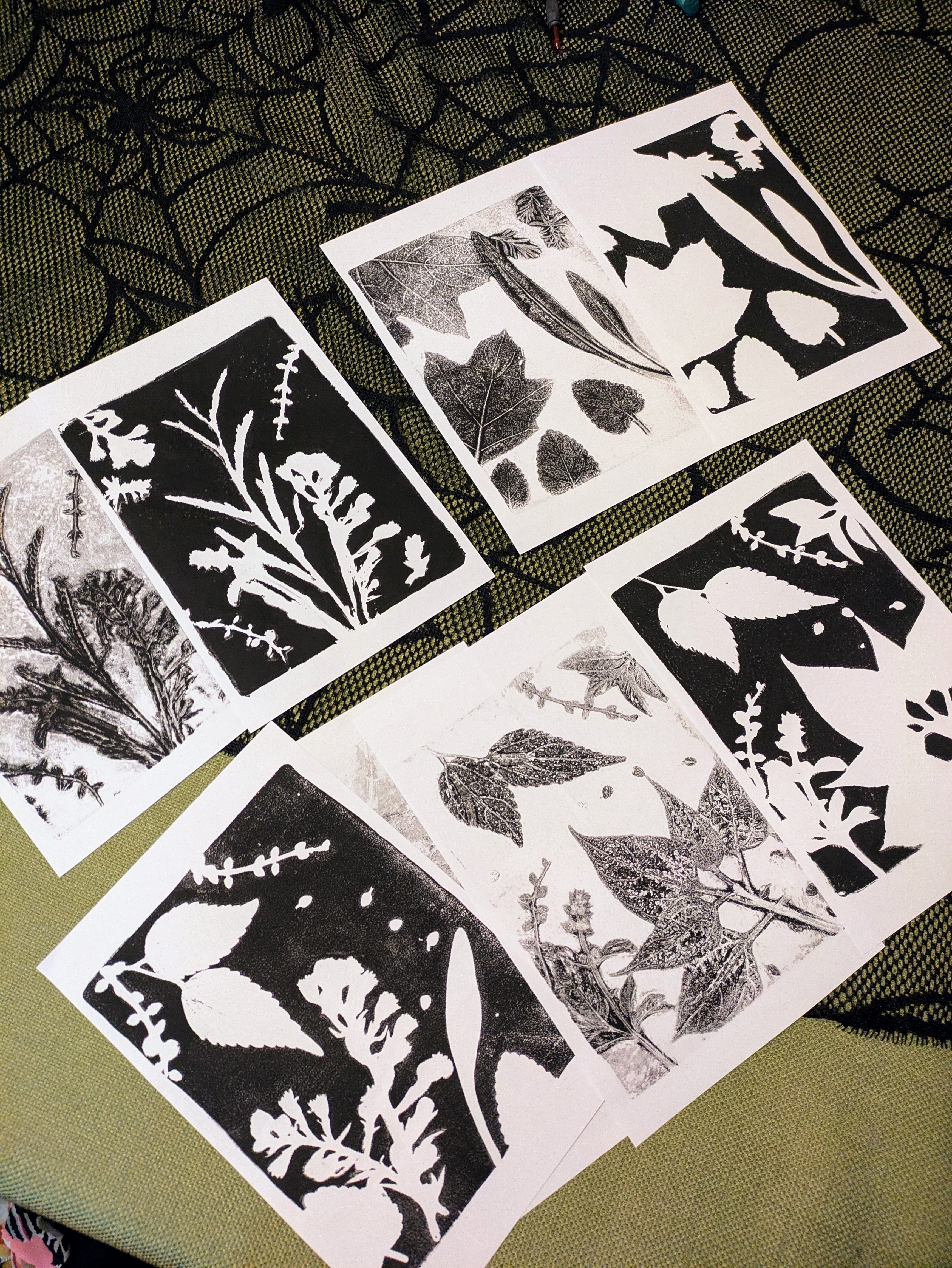 Several copies of screen print paper sit on the ground