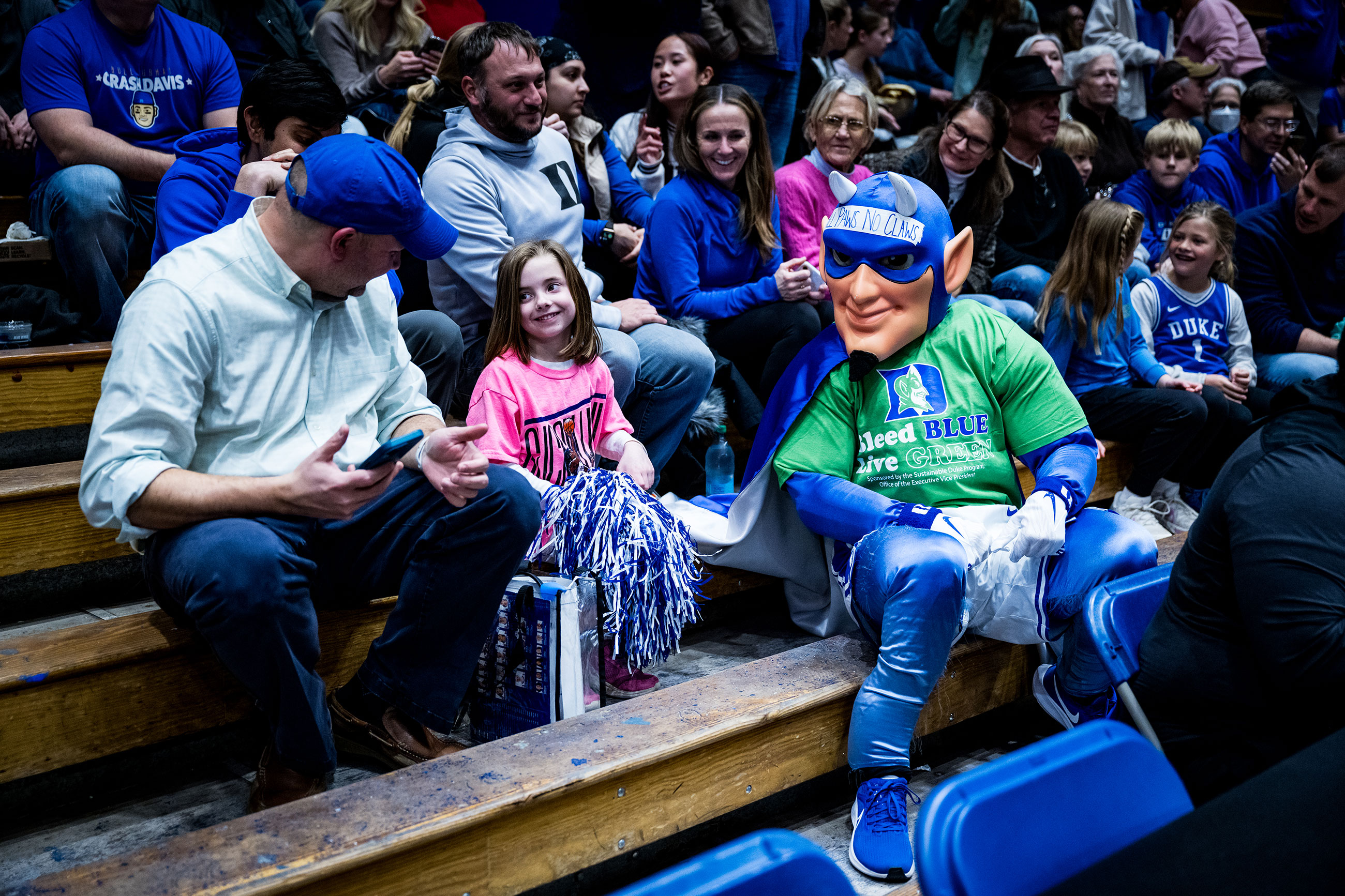 Wearing green for the day, the Blue Devil mascot entertains fans at the climate game.