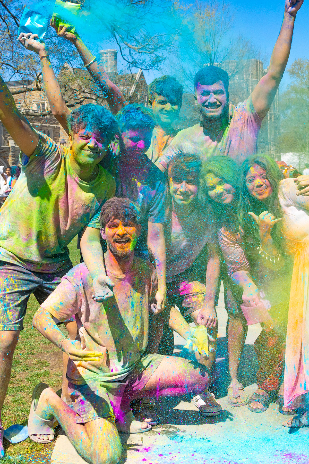 group of students celebrate covered with colors