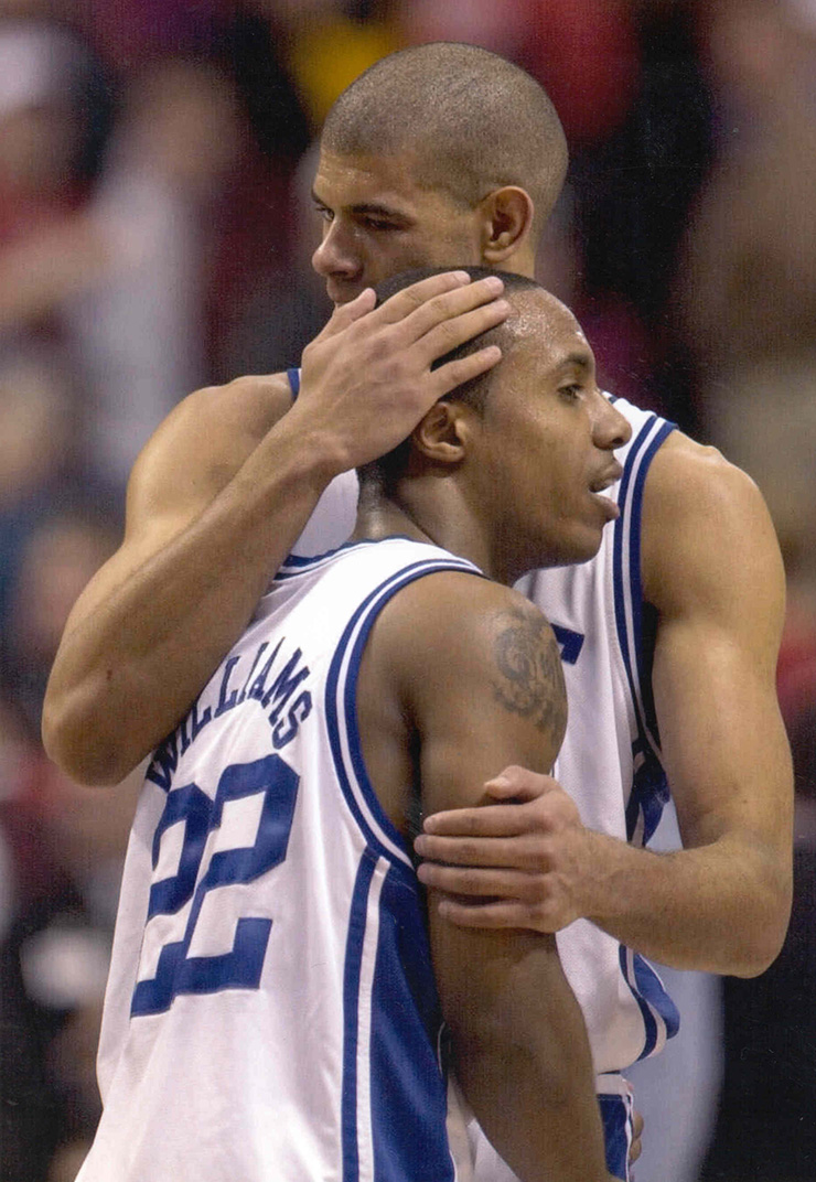 Shane Battier embraces teammate Jay Williams at Duke during a game