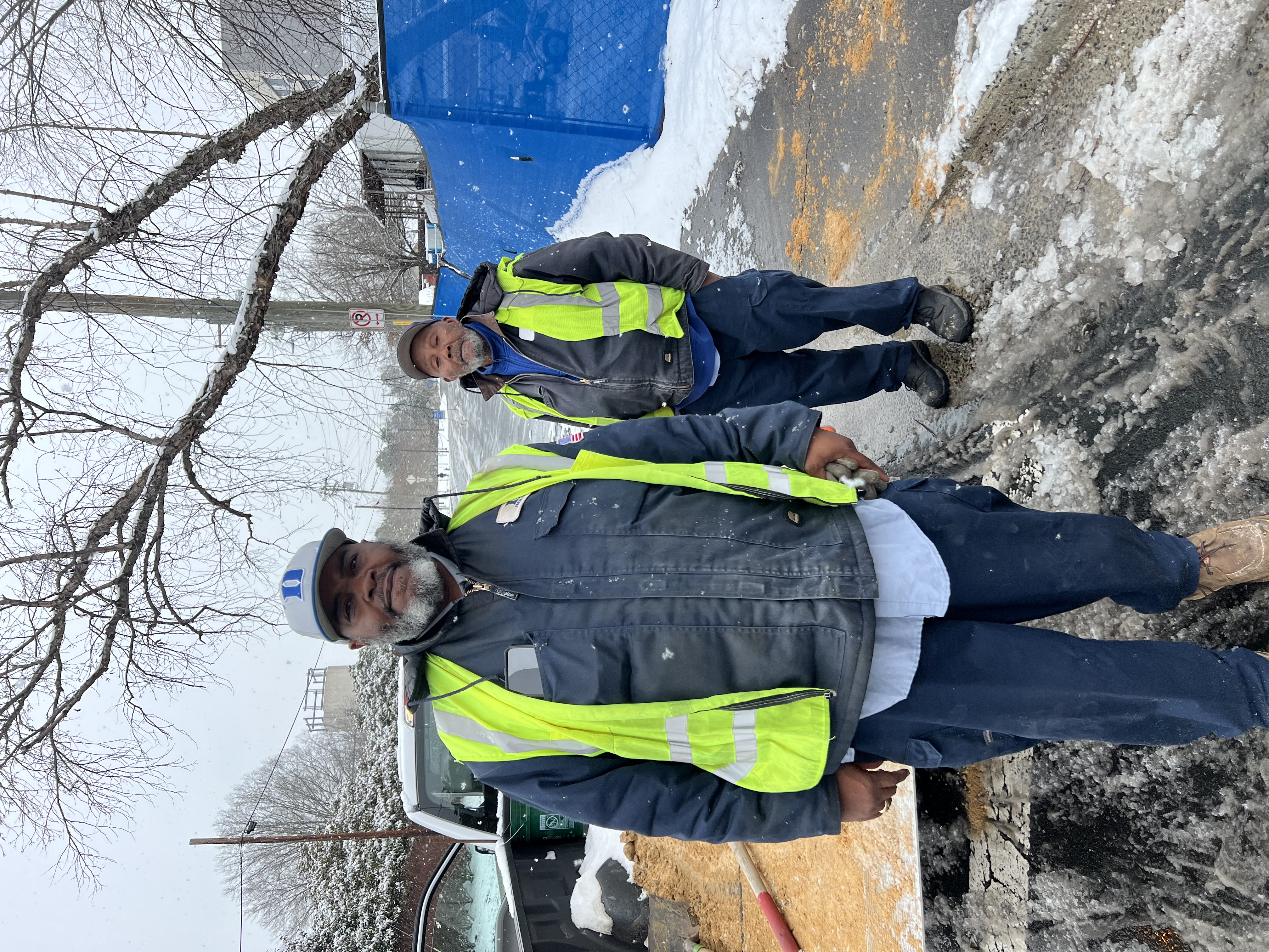 Wilford Hamm and Dan Farrar work to clear sidewalks on the Duke Health campus on February 20, 2025