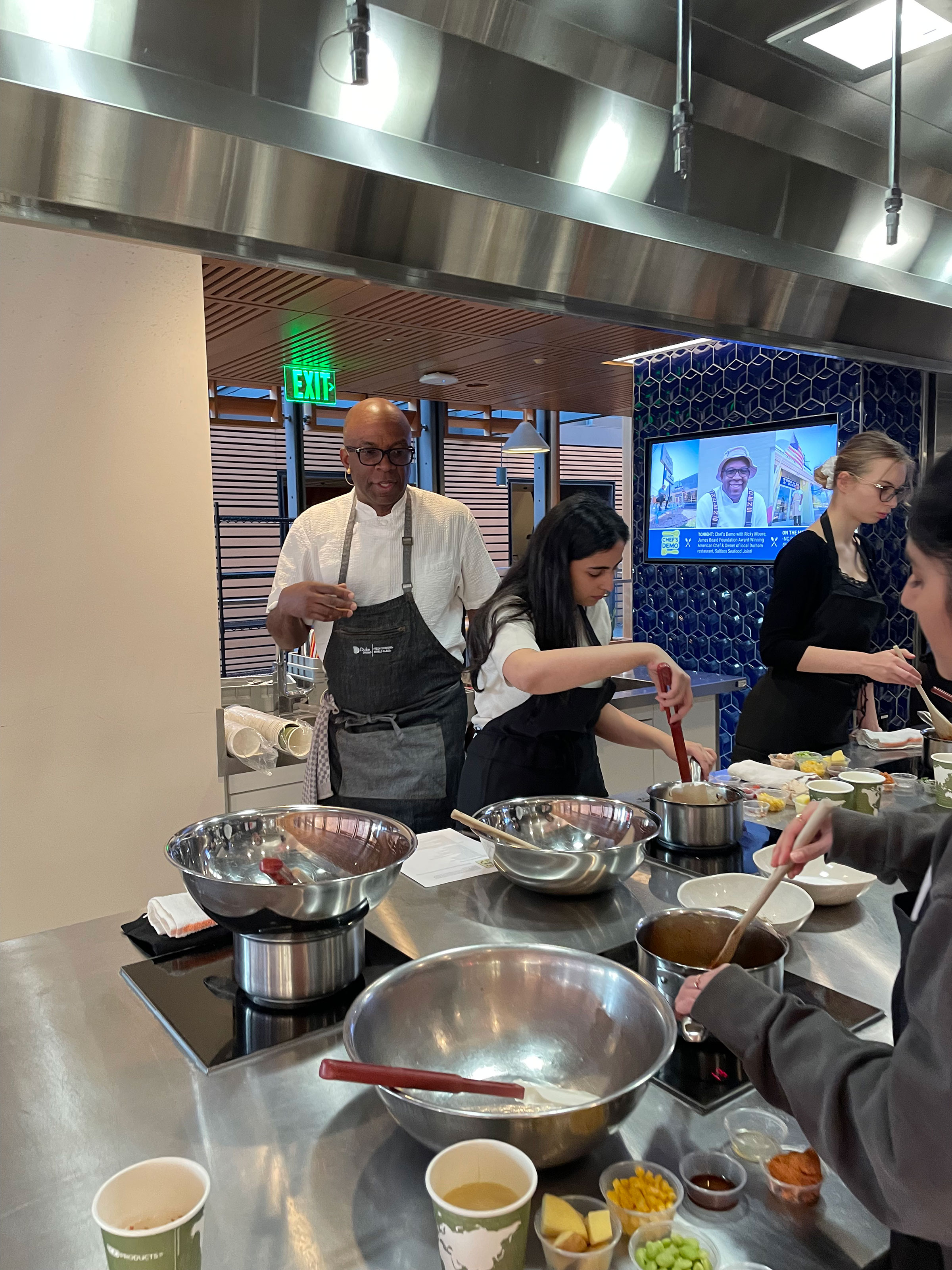 Moore watches over students as they make their own version of his dishes.