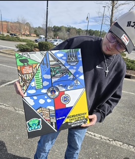 A man holds a painting of a mural design