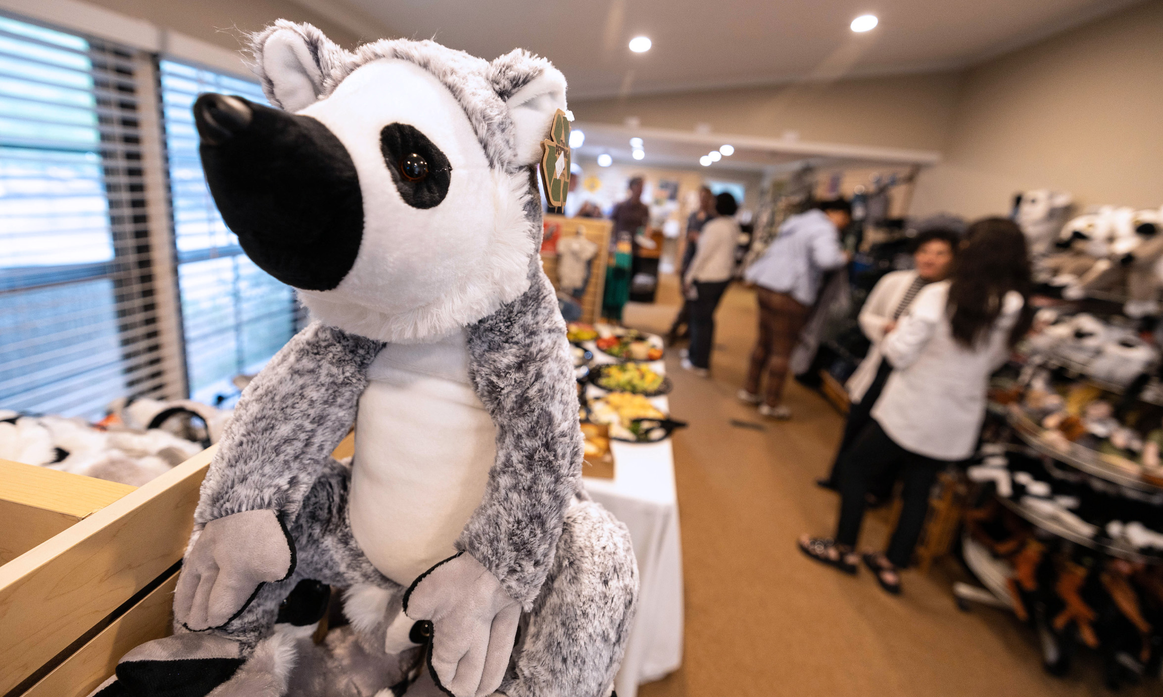 a stuffed animal lemur sits in the foreground of a Duke Leadership Academy networking event