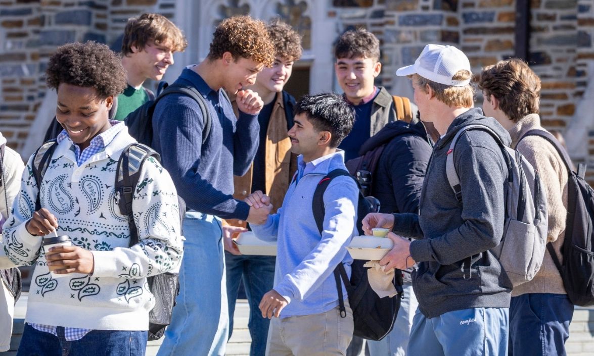 A group of students hatting together on west campus. 