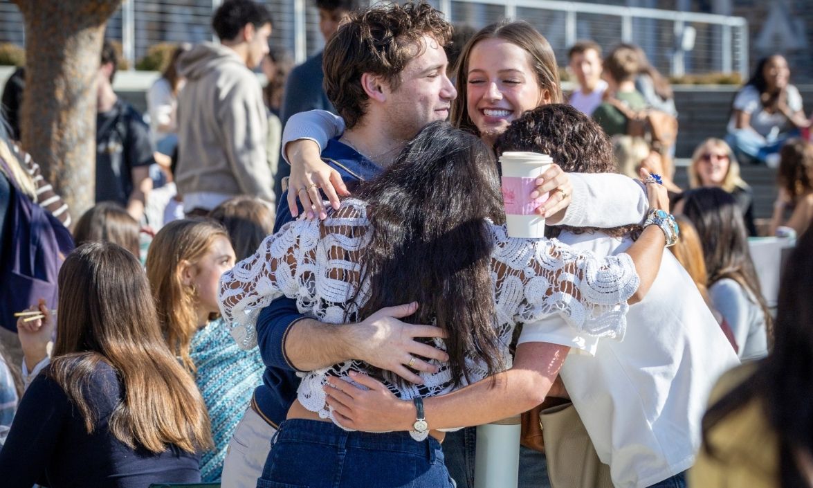 Students are hugging.