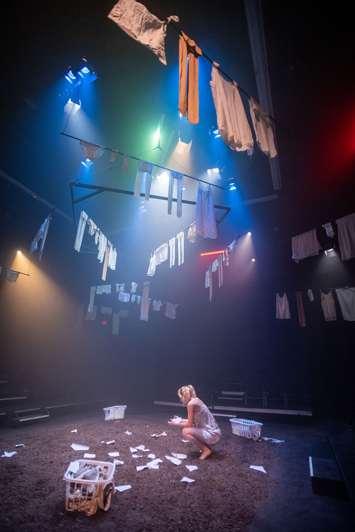 student actor during rehearsal. A single actor reads a note dropped on a ground
