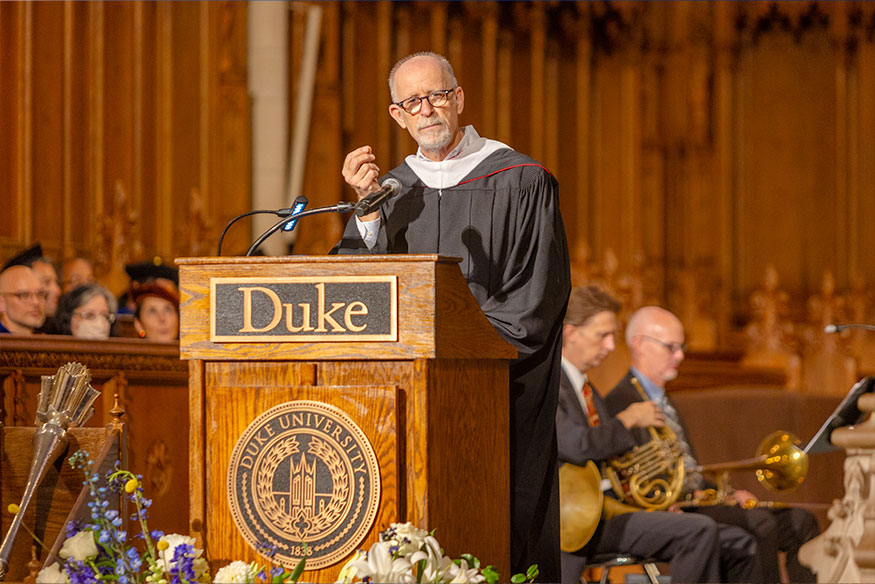 Christoph Gutentag speaking at the podium in Duke CHapel
