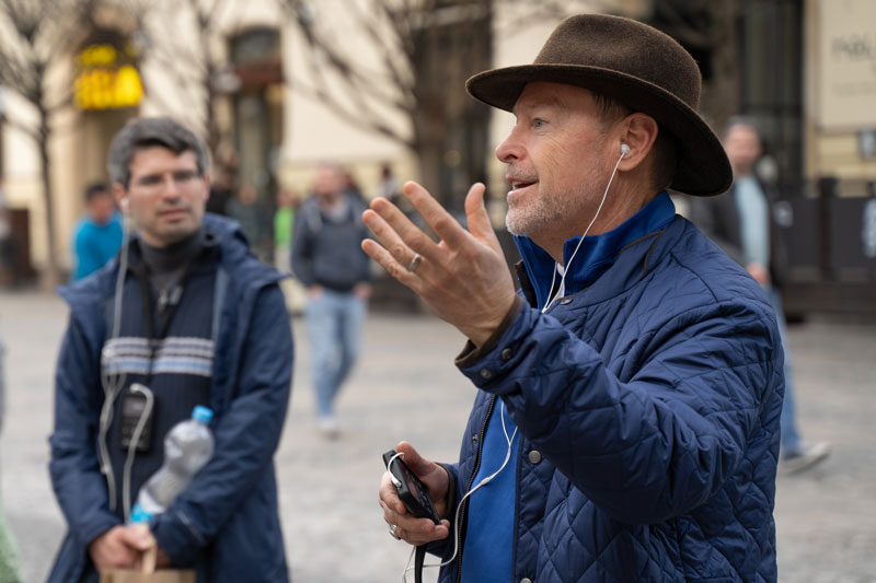 The subject of the talk gesturing with one hand up while adding context to the talk