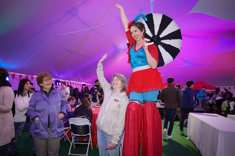 MIT’s campus was transformed Saturday for a community street fair in celebration of the inauguration. Under a tent on Hockfield court, President Kornbluth posed with one of the many acrobats who performed around campus. Photo by Jodi Hilton.