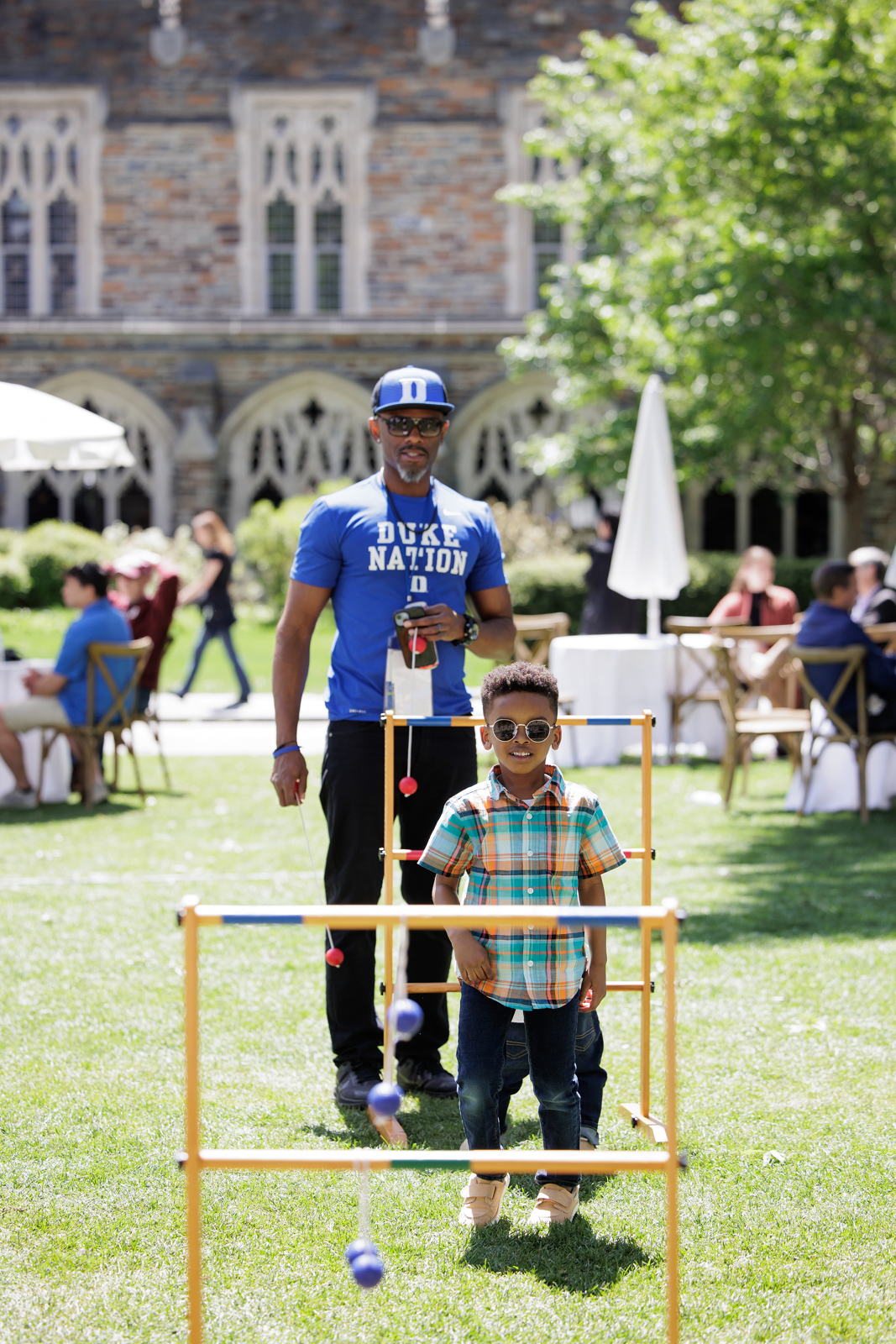 Left: An alumnus family enjoys a ladder toss game during the cool, sunny weather on campus. 