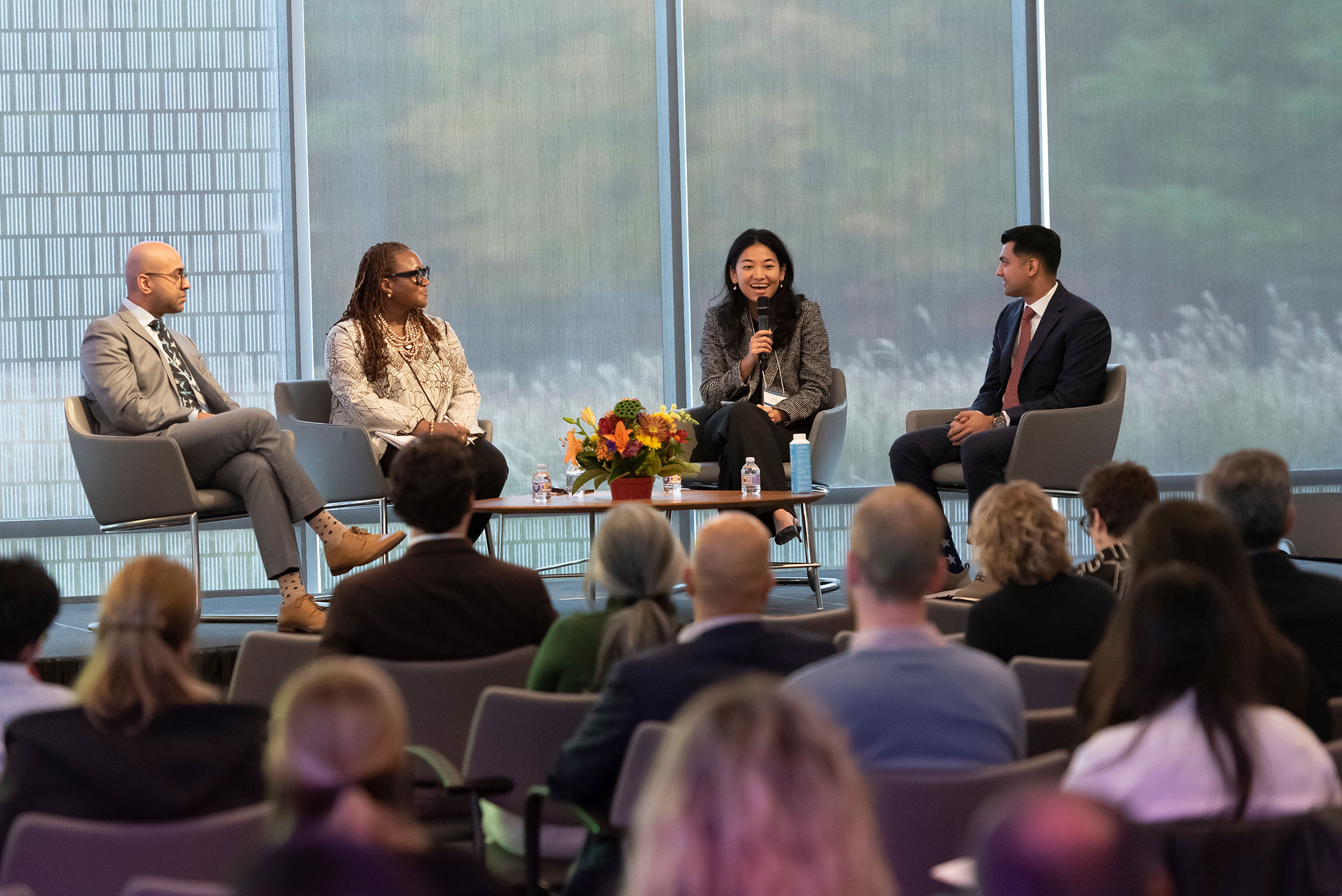 Jenny Wu, MD, a resident in the Department of Obstetrics and Gynecology, makes a point during a panel discussion with (from left) Haider Warraich, MD, of Harvard Medical School; Andrea Anderson, MD, of George Washington School of Medicine and Health Sciences; and Hussain Lalani, MD, MPH, of Harvard Medical School.
