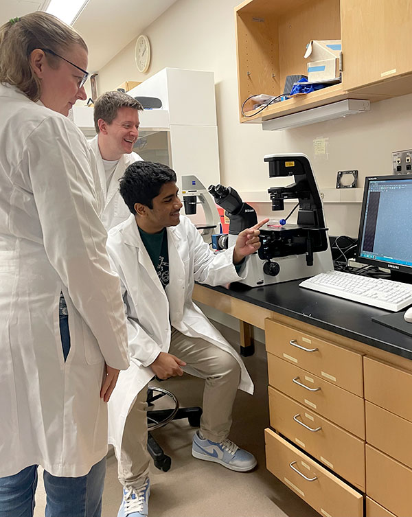 Rashad Rahman with mentors Dr. Philip Mzyk and Kristin Perkumas in the Stamer lab at the Duke Eye Center.
