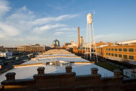 The Durham skyline and the "Lucky Strike" tower are seen at sunset as seen from the American Tobacco Campus.