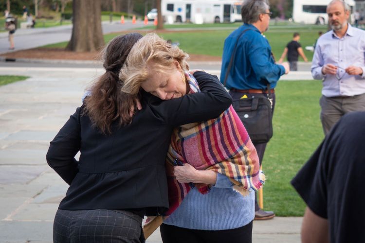 Professor of Polish and Russian Studies Beth Holmgren receives a hug following the vigil.