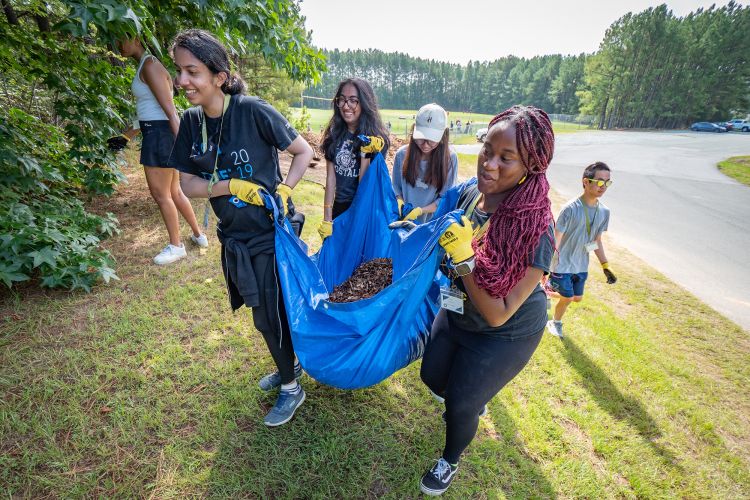 First year students spent a morning at Durham’s Southern School of Energy and Sustainability mulching tree beds and creating protection for new tree plantings. (Bill Snead/University Communications)