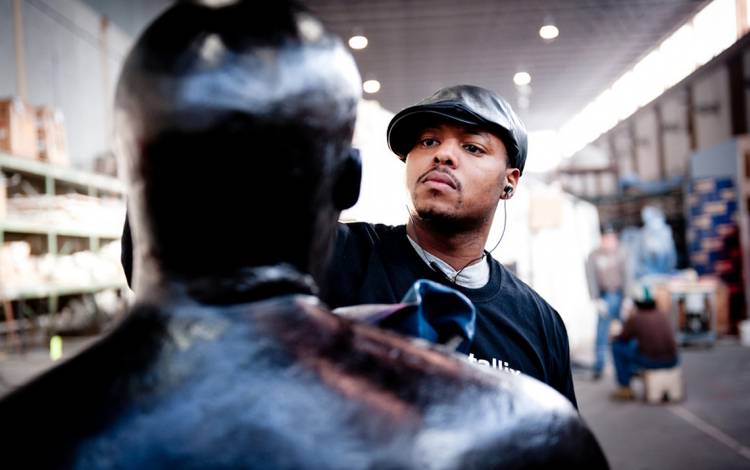 Artist works on a sculpture.