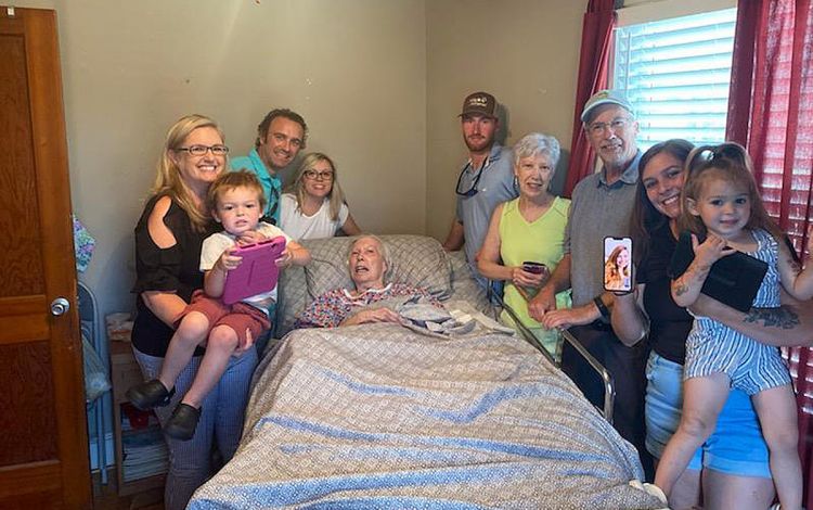 Family around a hospital bed.