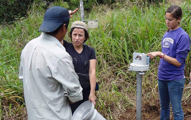 Barros, center, installing rainfall measurements in Peru.