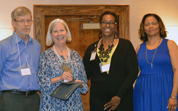 Anne Lacey, second from left, received the Share Your Christmas Key Volunteer award in 2018 from Durham Social Services. Photo courtesy of Anne Lacey.