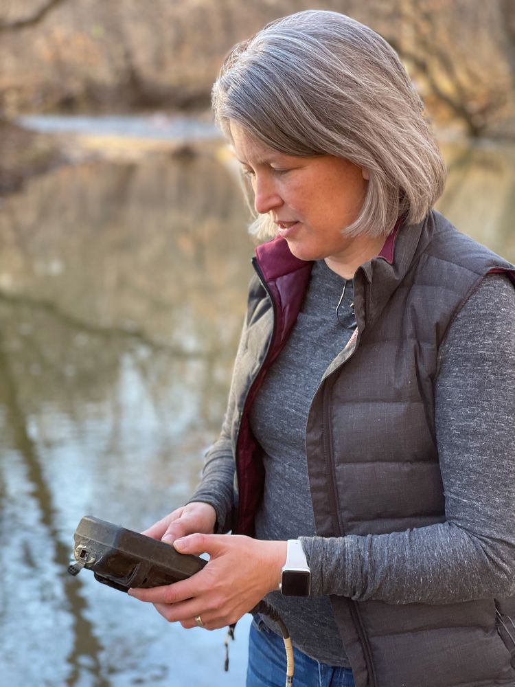 Duke ecologist and biogeochemist Emily Bernhardt checks levels of dissolved oxygen in the waters of New Hope Creek. Photo by Véronique Koch, Duke University