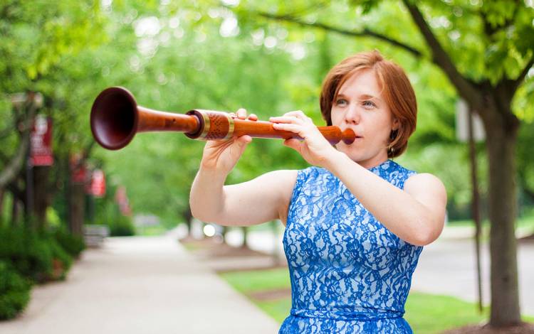 A woman playing a flute.