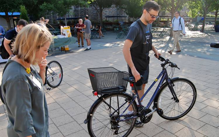 Ellen Byars, left, watches as Loschiavo begins to work on her bike.