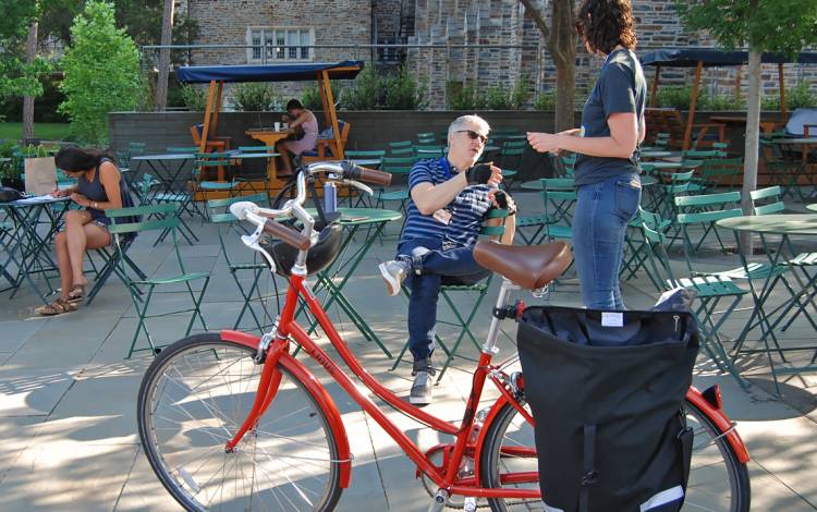 Duke library staffers Jeff Kosokoff, left, and Molly Bragg, right, talk at the Bicyclist Appreciation Breakfast.