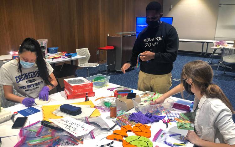 Duke students put together activity kits for Durham school children. Photo courtesy of Allie Sinclair.