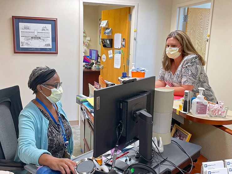 Carla Neal, right, is a source of information and encouragement for her Duke Regional Hospital colleagues. Photo courtesy of Duke Regional Hospital.