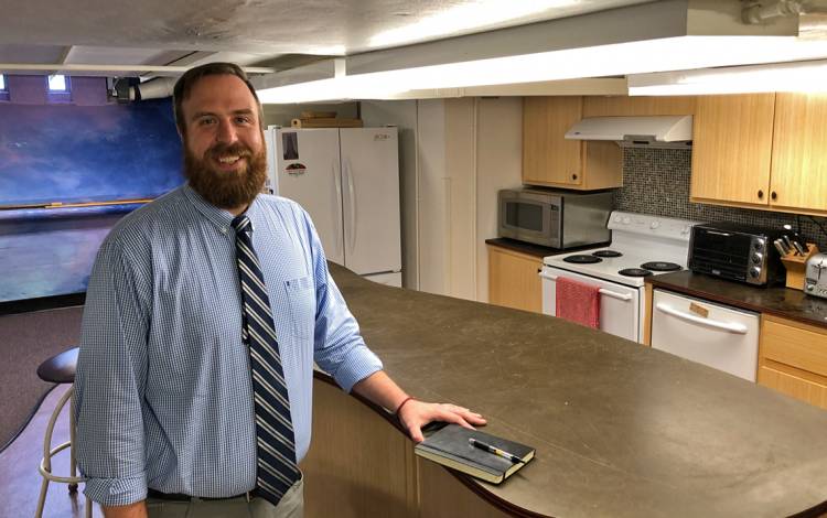 Michael Lyle moves around the basement of Duke Chapel with the building's low ceilings just inches from his head. Photo by Stephen Schramm.