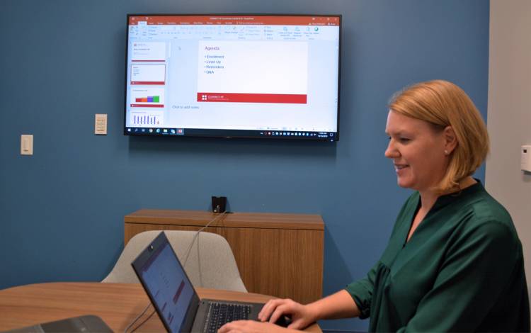 Tracy Hofmann leads conference calls with 160 participants. Photo by Jonathan Black.