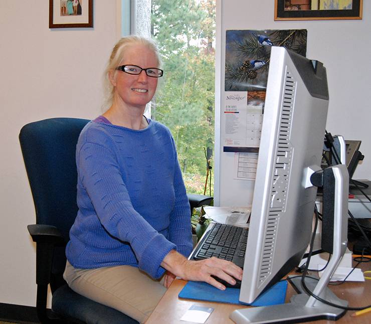 Alexandra Cooper of the Social Science Research Institute is one of Duke's Qualtrics experts. Photo by Stephen Schramm. Alexandra Cooper at her desk.