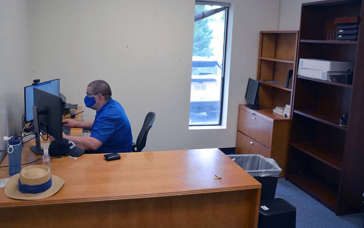 Cort Schneider works from the offices of the Duke Disability Management System. Photo by Jonathan Black.