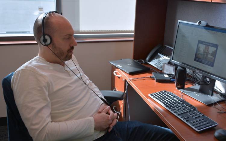 Putting on headphones helps Daniel Hatch meditate. Photo by Jonathan Black.