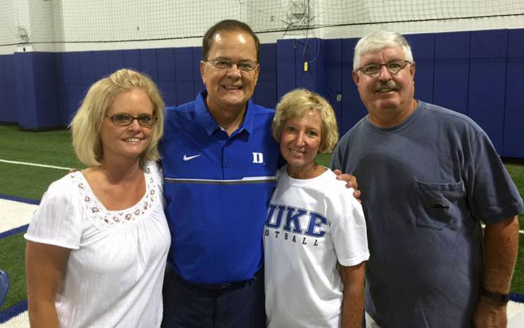 Donna Flamion, left, poses with Duke Football Coach David Cutcliffe, second from left, and friends. Photo courtesy of Donna Flamion.