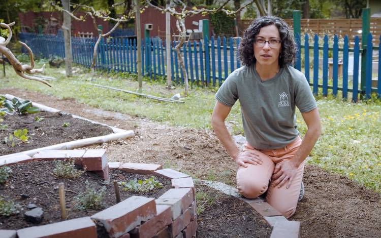 Kavanah Anderson, a youth education coordinator at Sarah P. Duke Gardens, explains the benefits of an herb spiral.