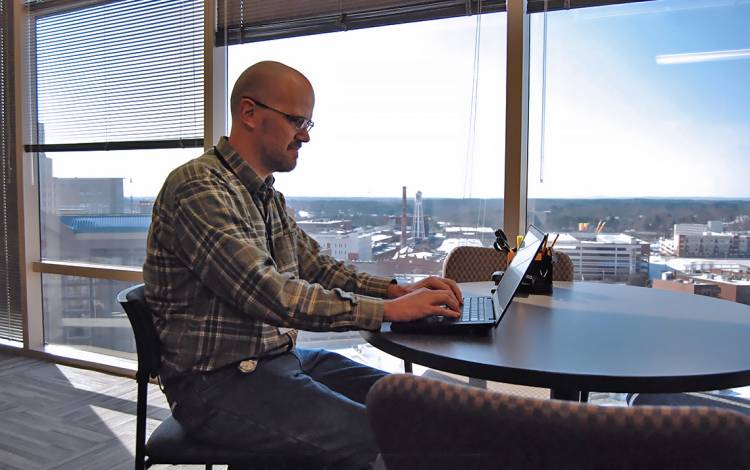 As one of the Duke Clinical Research Institute employees on the 10th floor of Durham Centre, Brad Conant enjoys expansive views of downtown Durham.