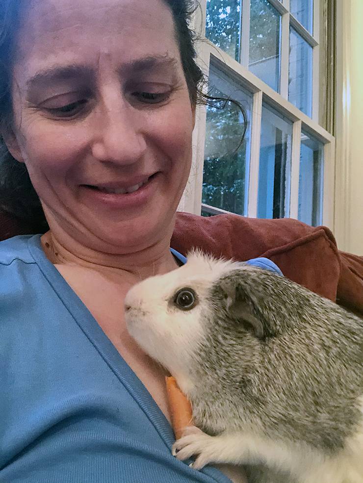 Emily Hecker cuddles with Dustin while he snacks on a carrot. Photo courtesy of Emily Hecker.