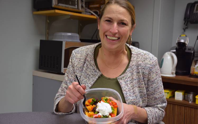 Esther Granville packs a lunch with sweet potatoes, black beans, bell peppers and greek yogurt. Photo by Jonathan Black.