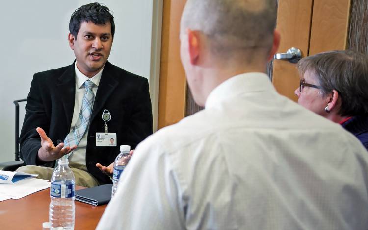 Karthik Shyam, director of communications for Duke’s Population Health Management Office, talks with members of the Medicare Beneficiary Advisory Council, a patient group that advises the office. 