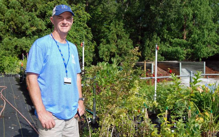 With greenhouses, bees, plants and machines, there's plenty to keep Bobby Mottern and his staff busy in the Duke Gardens' support area. Photo by Stephen Schramm.