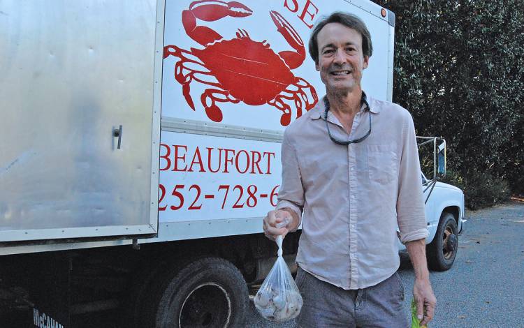 Walking Fish, a consumer-supported fishery, brings fresh fish and shellfish from the North Carolina coast to community members such as Duke Professor Orin Starn. Photo by Stephen Schramm.