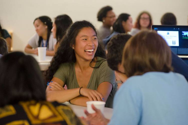 Students in the interdisciplinary discussion FOCUS course listen to a speaker during their weekly dinner session.  Photo by Susie Post-Rust